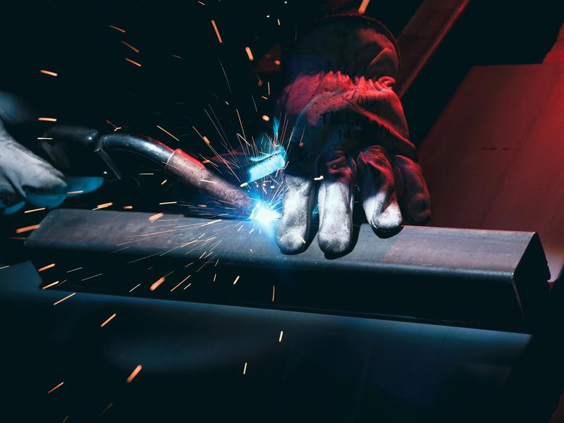 Welding a steel tube, arc and sparks